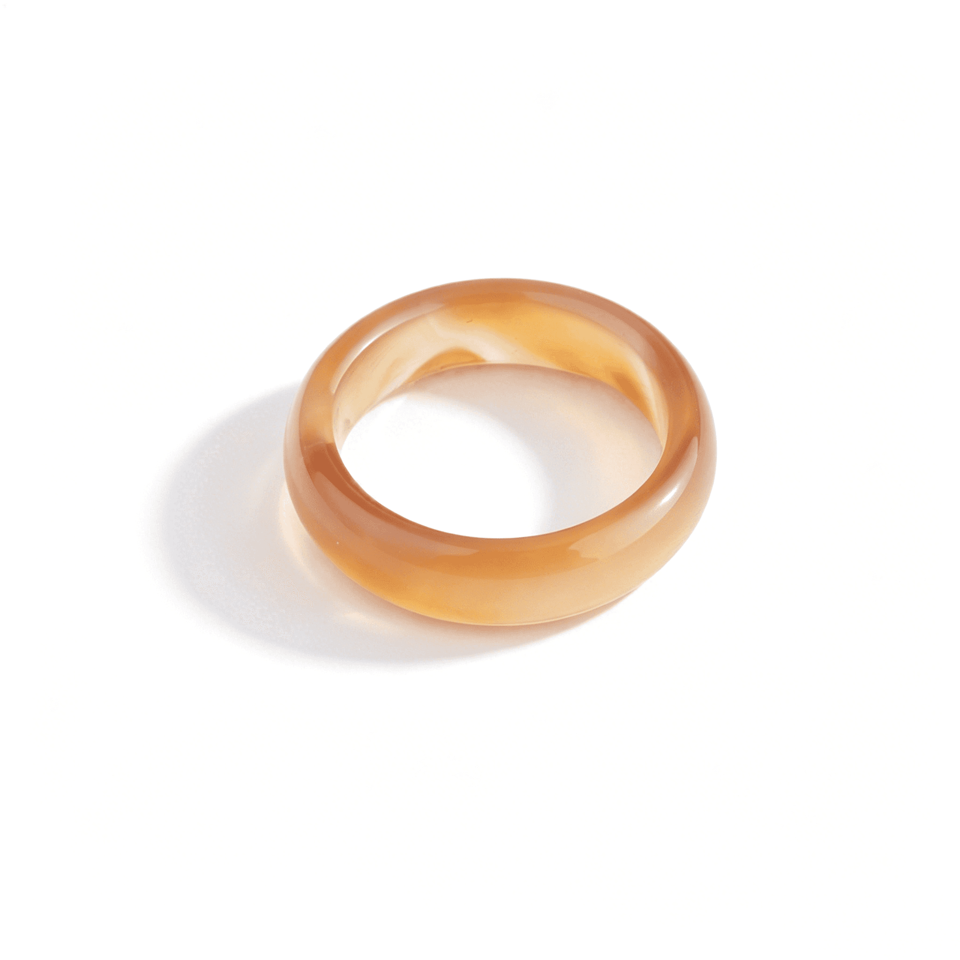 An angled shot of the honey-toned chalcedony ring, highlighting its semi-transparent quality and elegant organic shape.