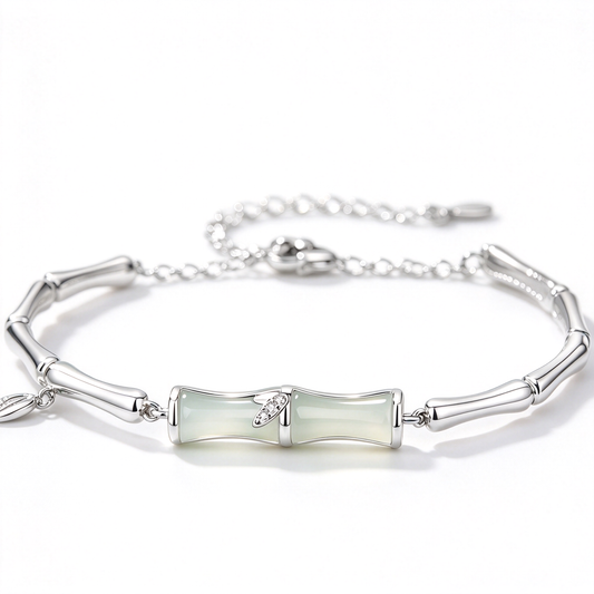 Silver-tone bracelet featuring pale green center segments, a decorative leaf accent, and a linked chain.