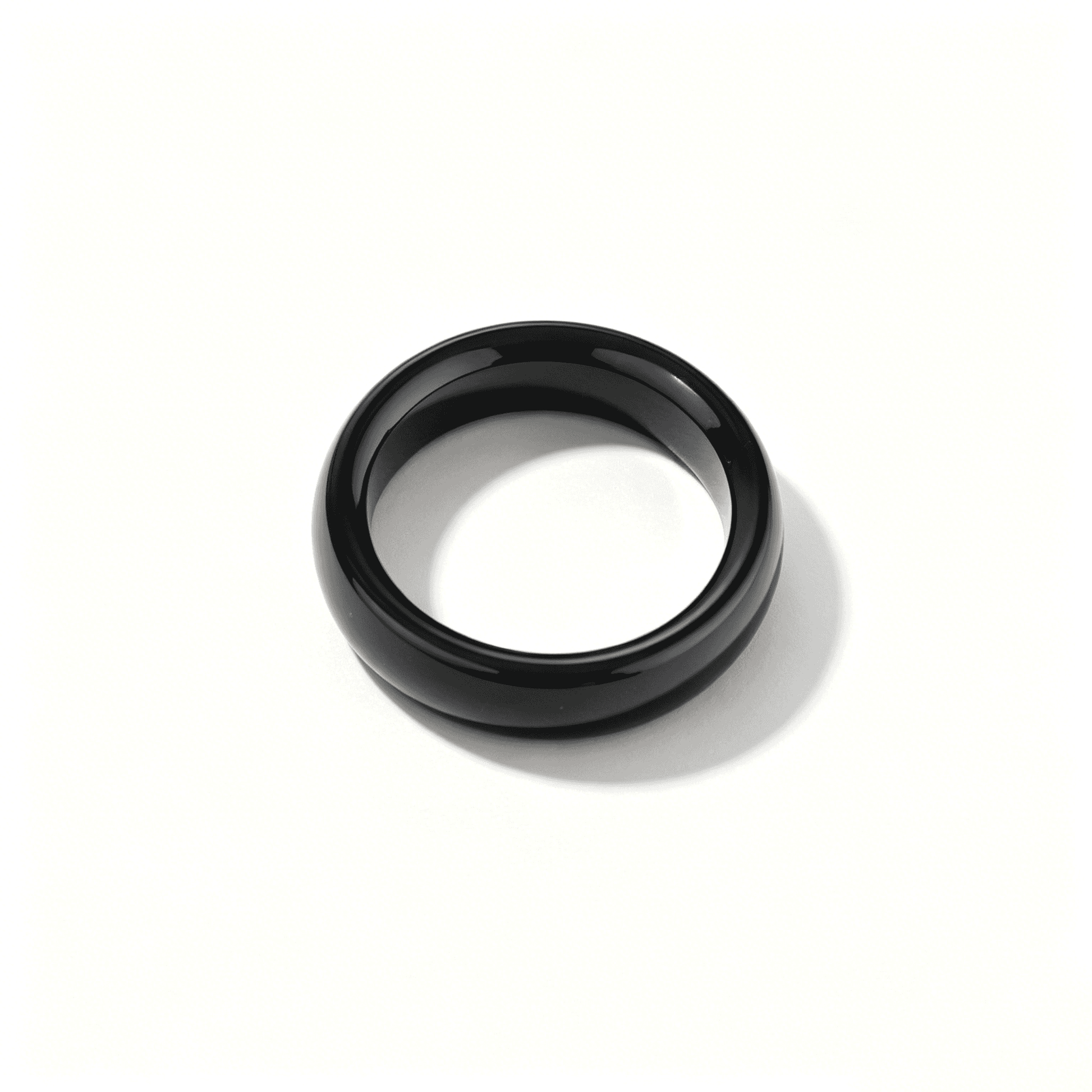 An angled shot of the black onyx chalcedony ring, highlighting its smooth hand-polished surface and elegant organic shape.