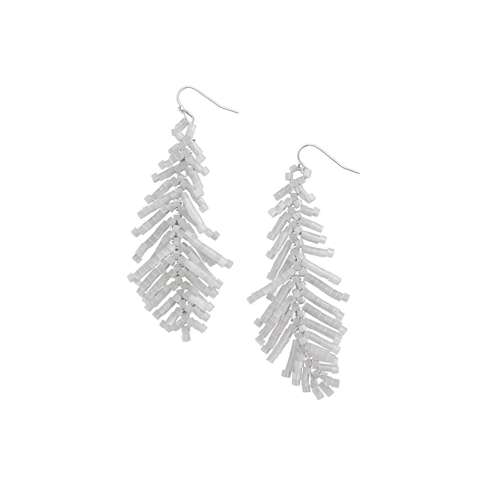 Studio profile of Ever P. handcrafted white seed bead palm leaf fringe earrings hanging from sleek silver-plated metal hooks.