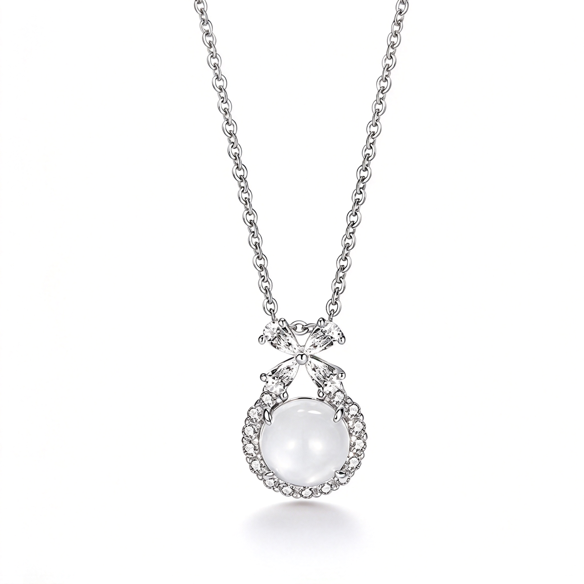 Bow pendant necklace with a round white centerpiece and decorative accents on a white background.