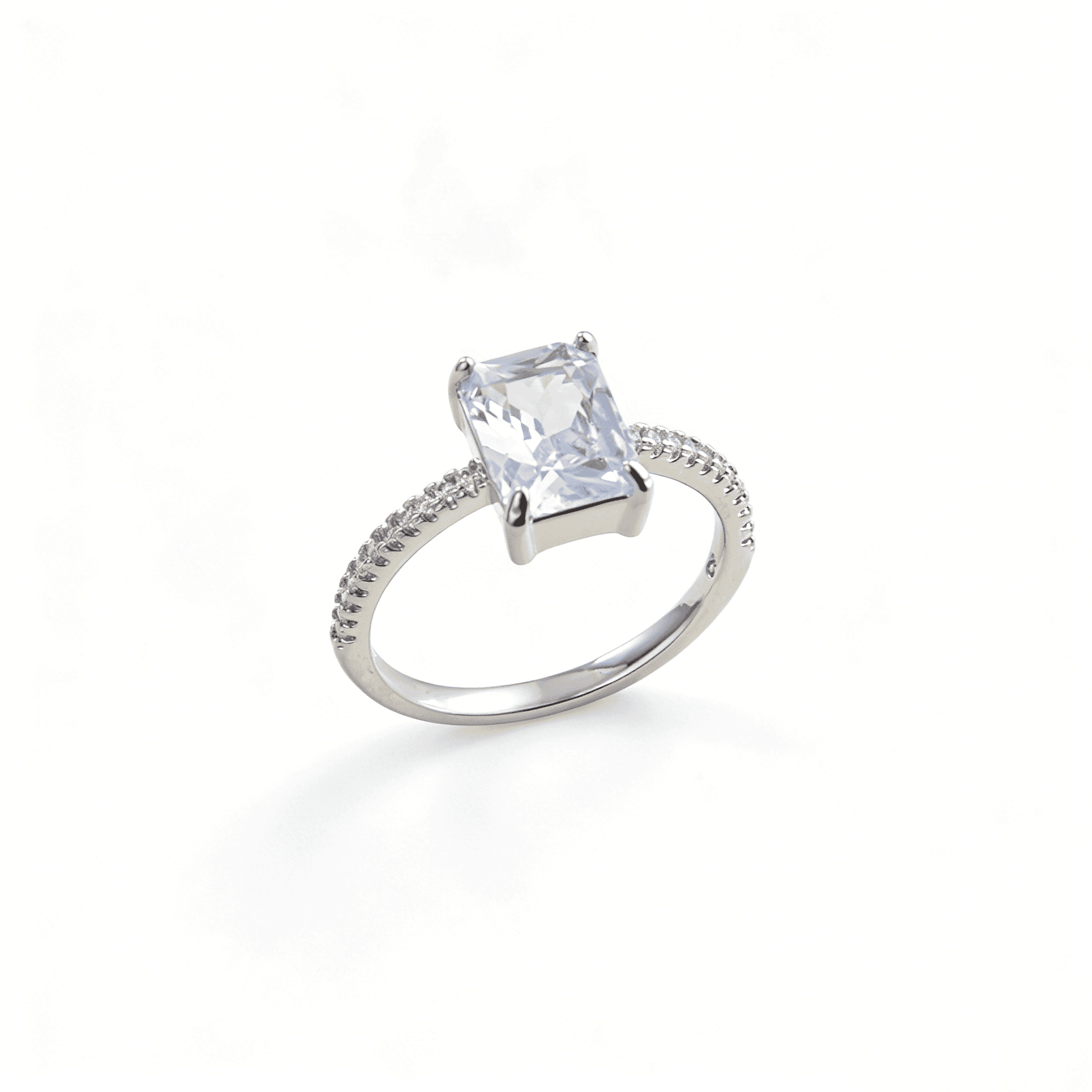 Detailed angled view of brilliant emerald-cut CZ solitaire ring showcasing its geometric facets.