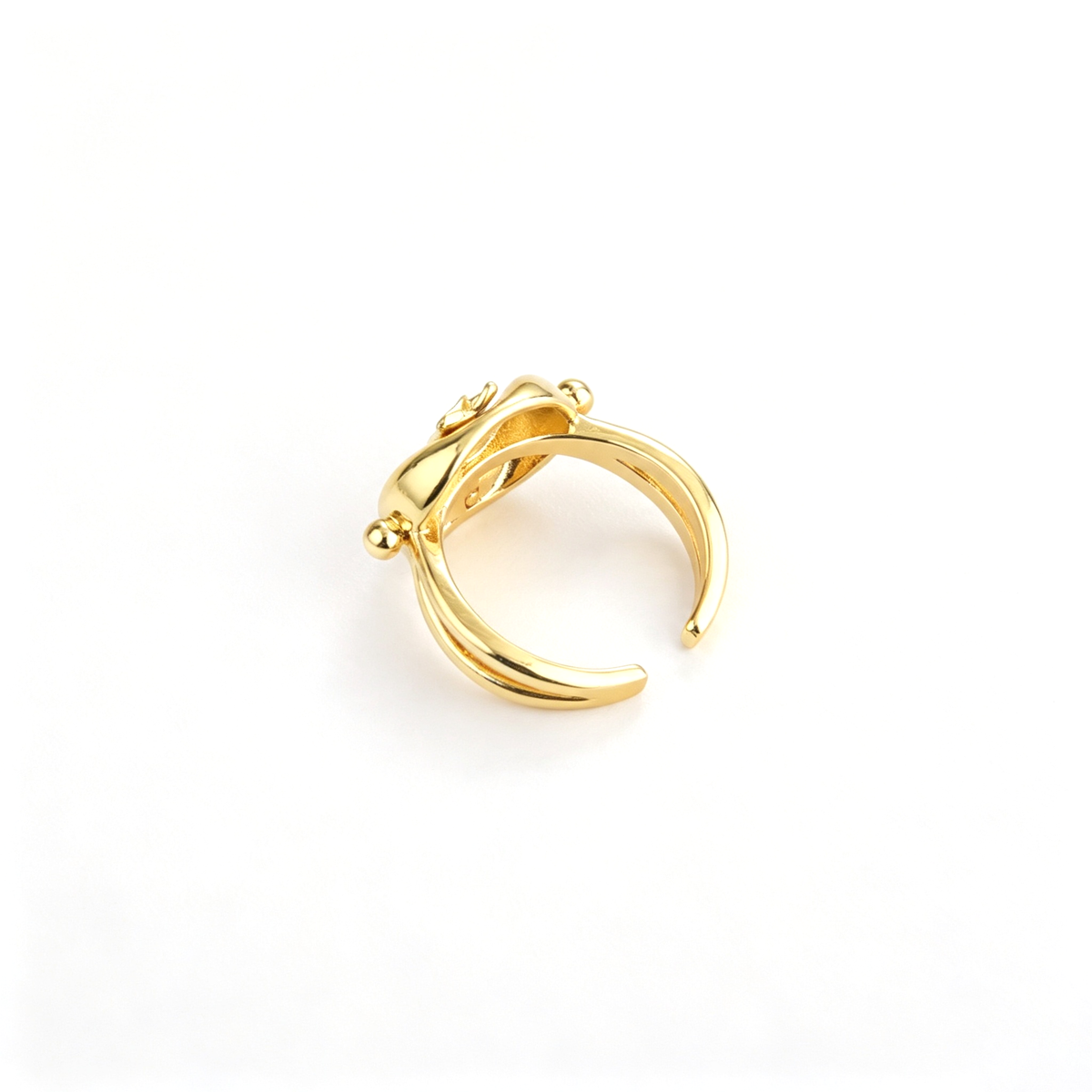 Sculptural cat ring shown from the front, highlighting the central figure and open cuff