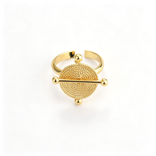 Celestial disc cuff bracelet with a circular centerpiece and horizontal bar detail
