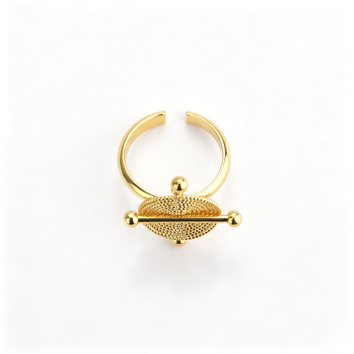 Open cuff bracelet shown from an angled side view with the textured disc centerpiece