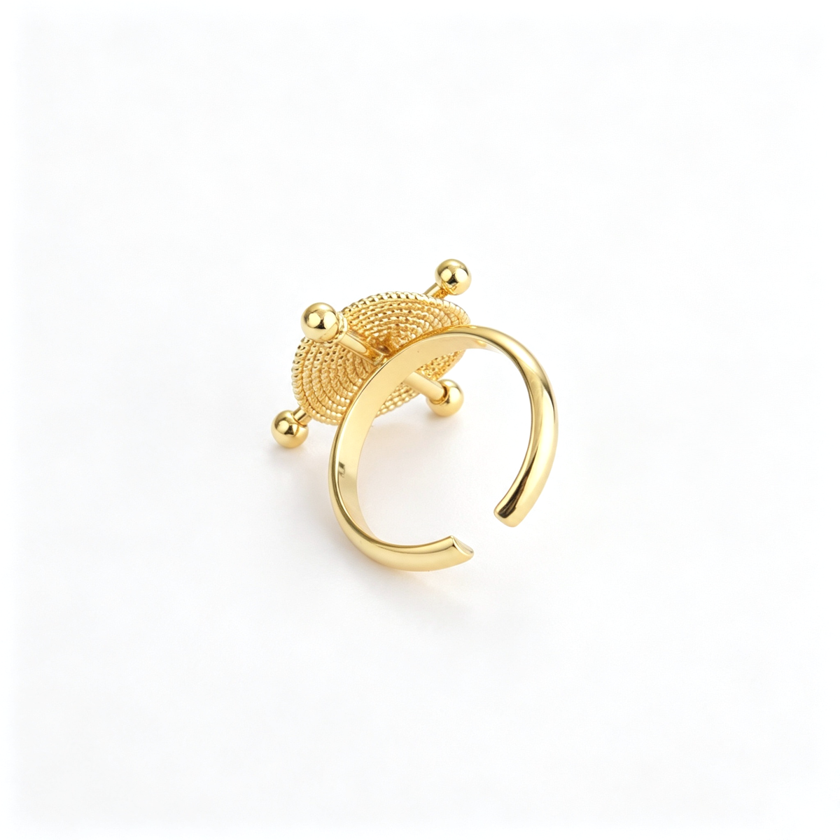 Side profile of the cuff bracelet highlighting the circular centerpiece and crossing bar