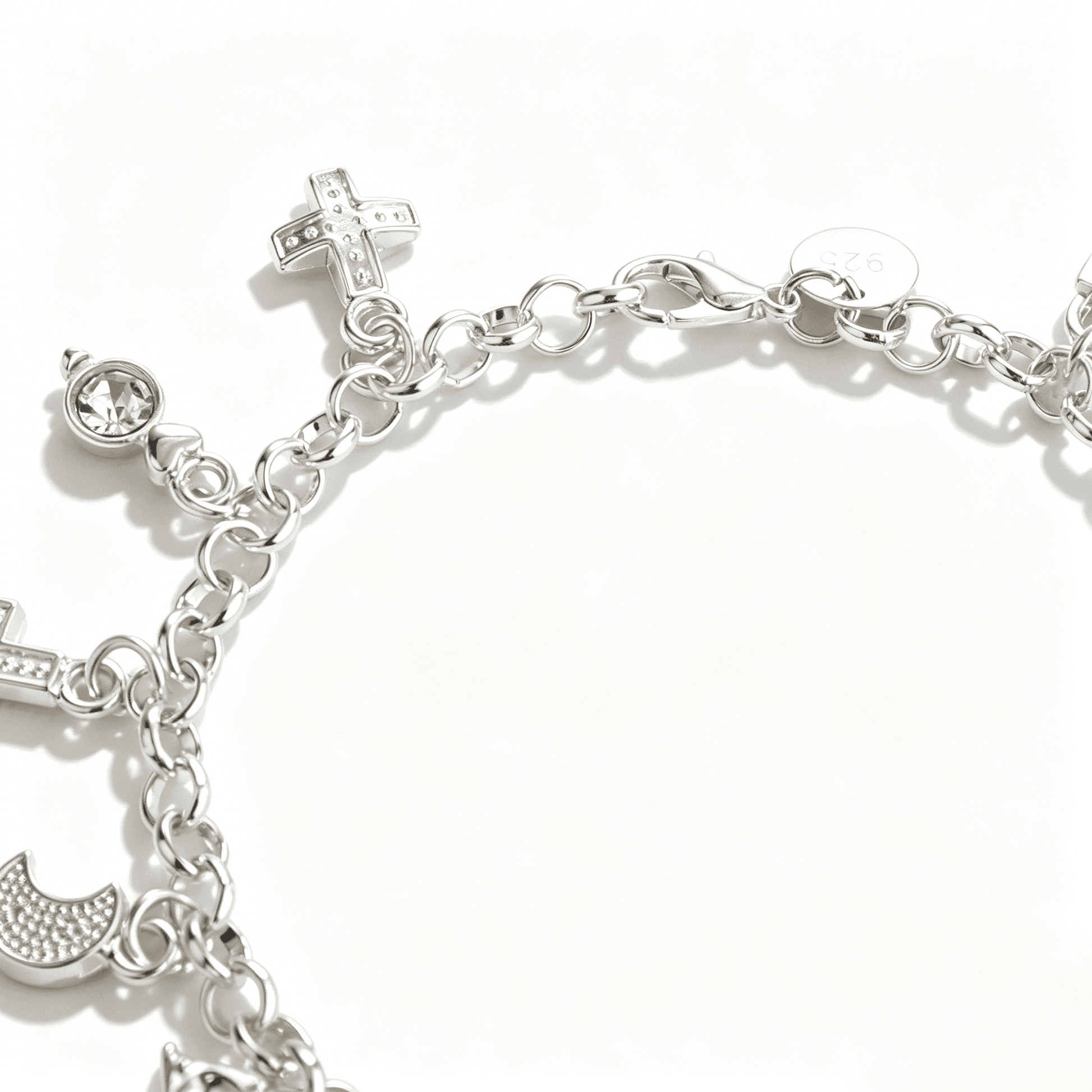 Close view of the secure lobster claw clasp and rolo link chain structure of a sterling silver charm bracelet for women.