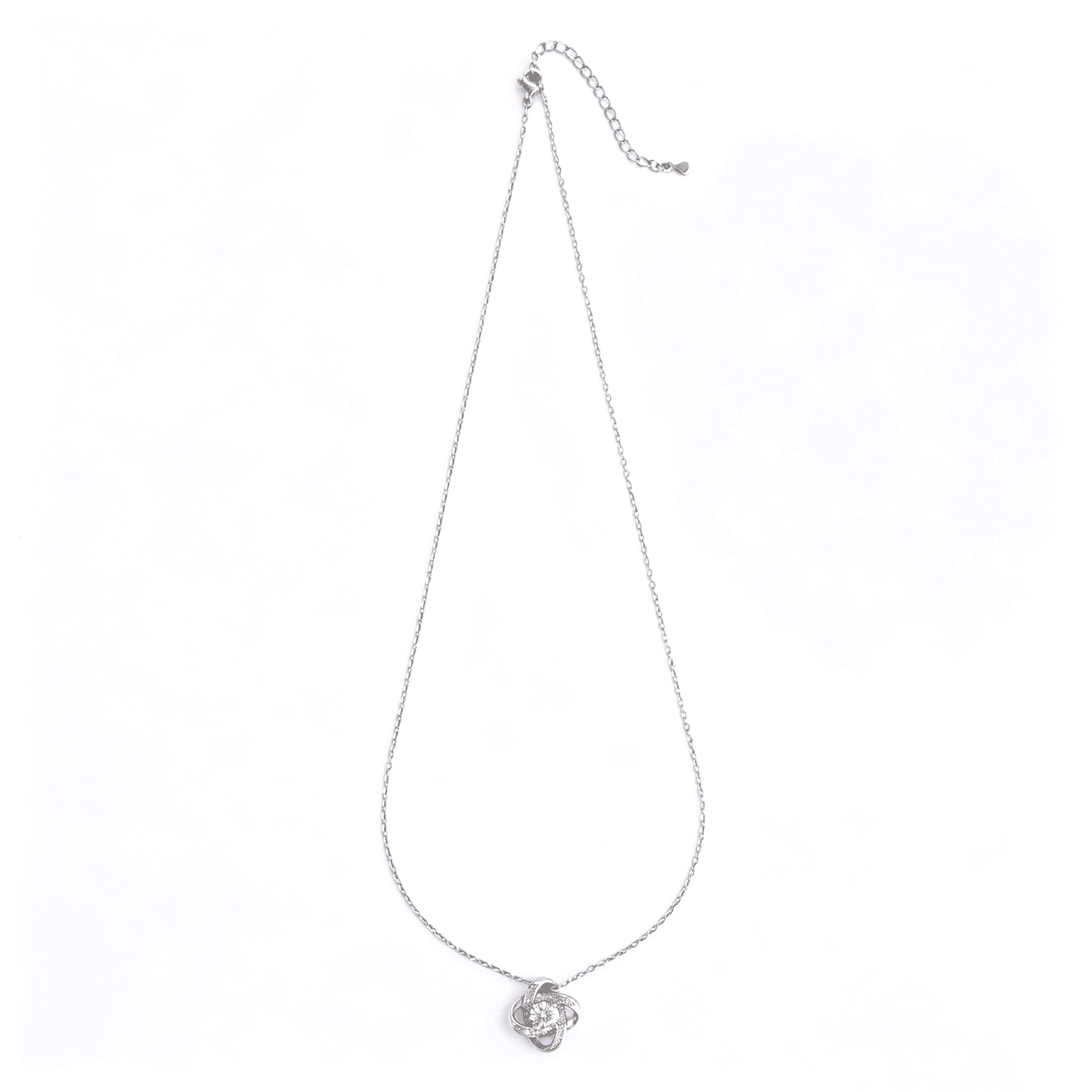 Complete studio view of the classic silver-plated love knot cz pendant necklace with an adjustable cable chain.