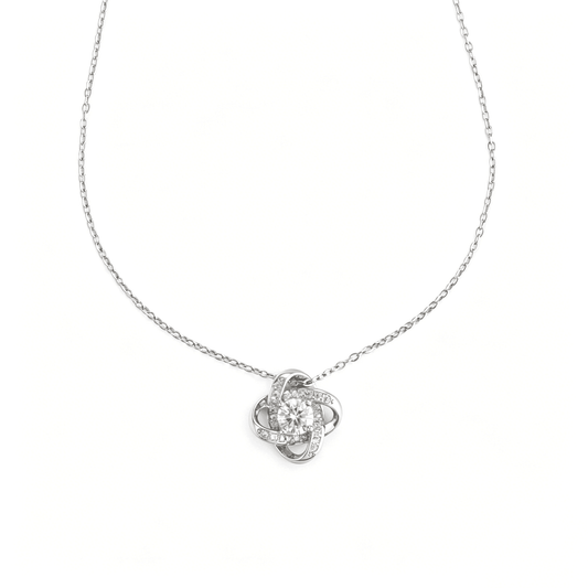 Front detailed perspective of the polished silver intertwined love knot charm highlighting the central cz diamond stone.