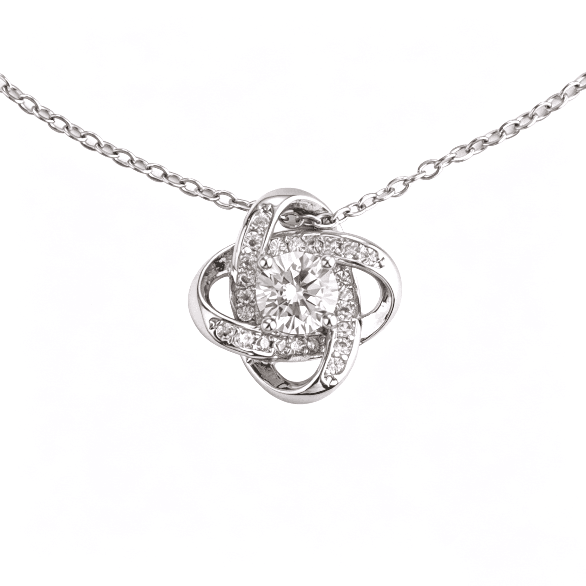 Extreme close-up of the brilliant 6mm round-cut cubic zirconia focal stone inside the silver love knot.