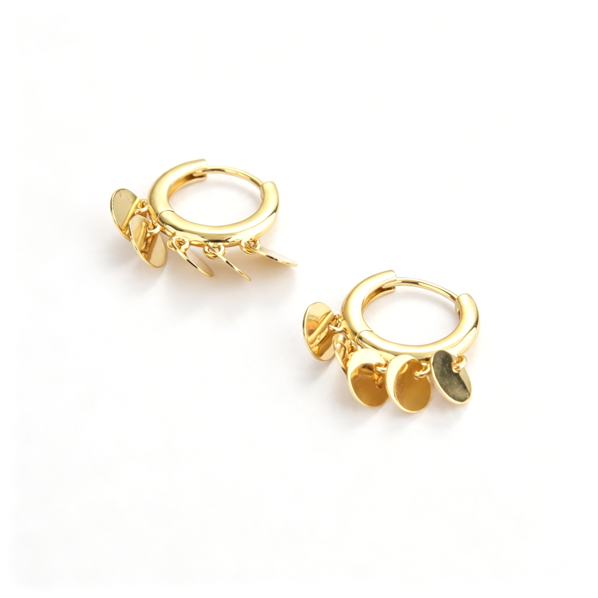 Coin charm hoop earrings with multiple dangling disc charms in an angled view