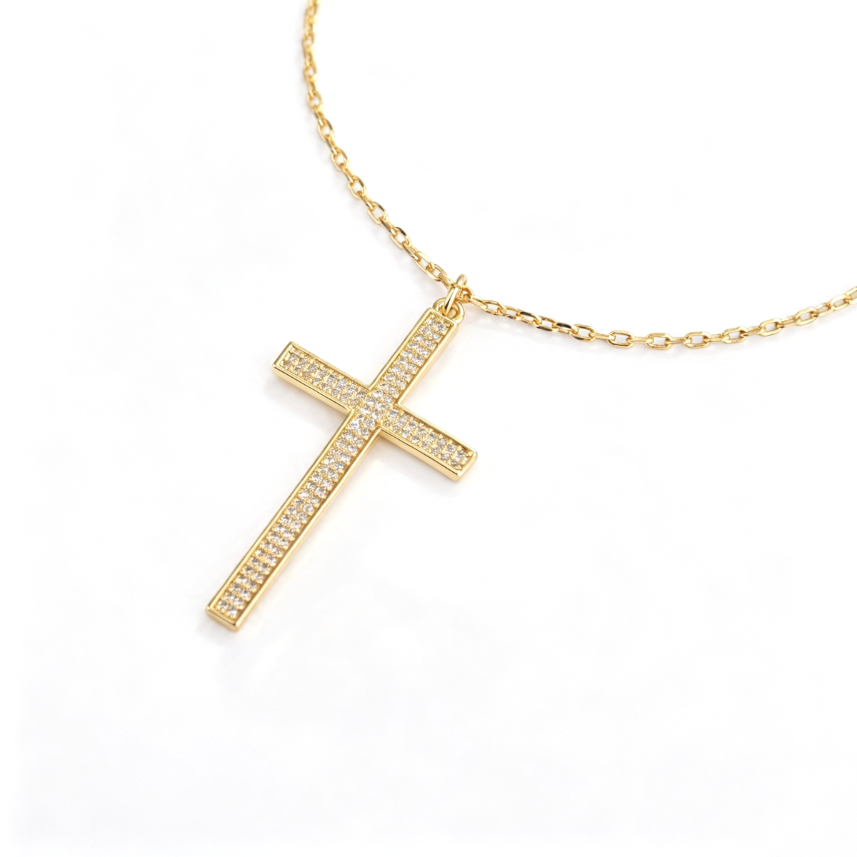 Full view of the cross necklace showing the chain, pendant, clasp, and extension