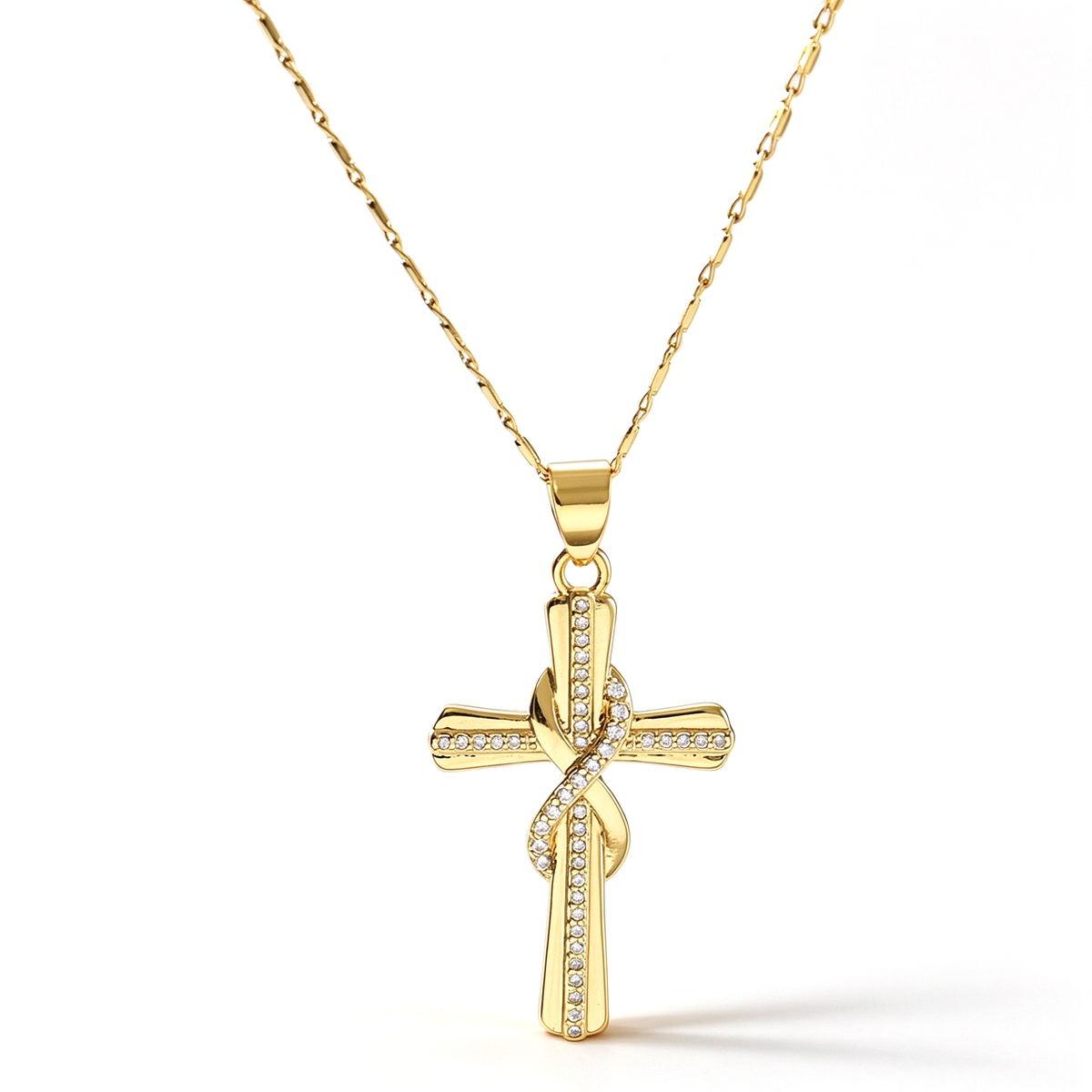 Gold-tone cross pendant necklace with sparkling accents displayed against a white background