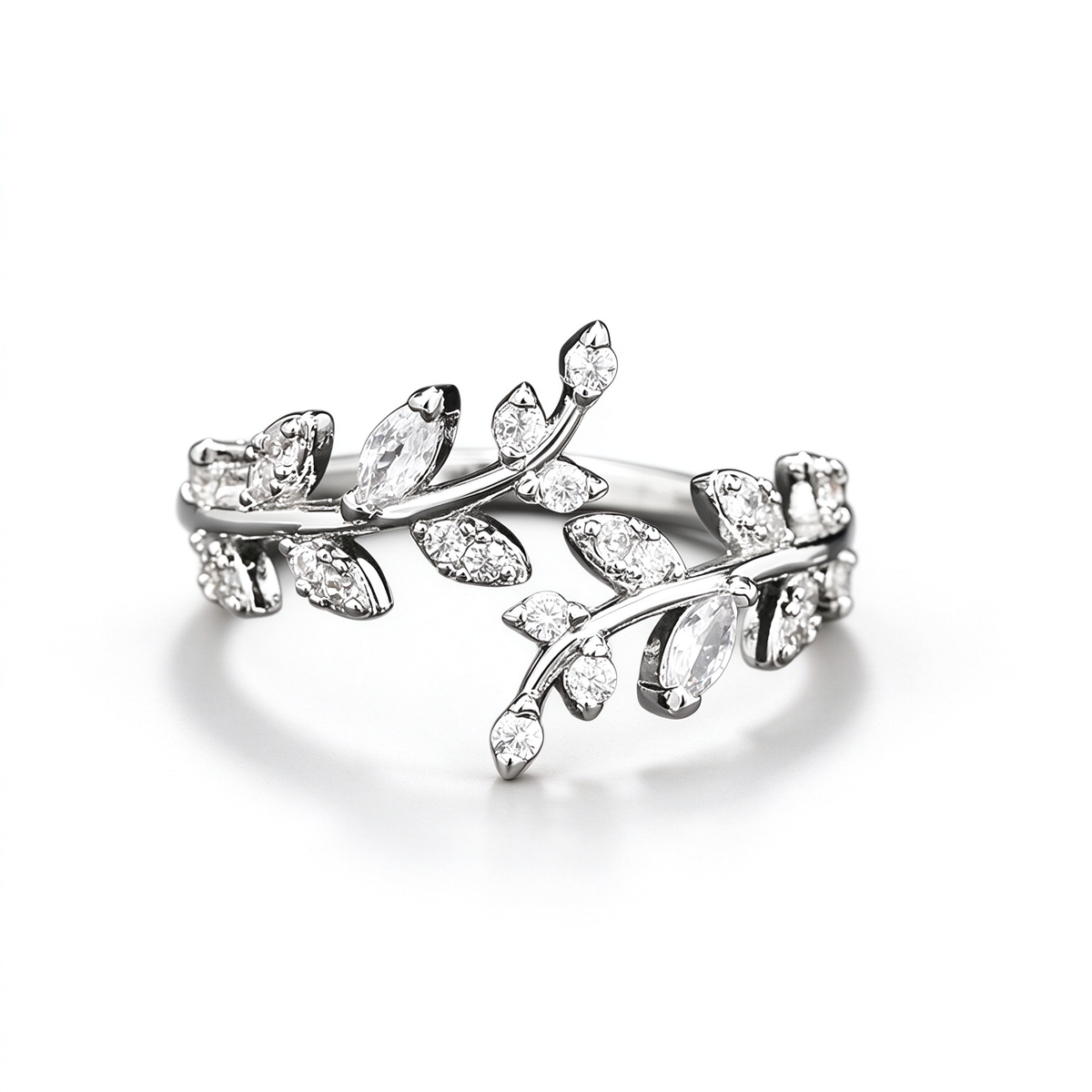Silver-tone open ring with curved vine branches and leaf-shaped decorative accents, shown from the side.