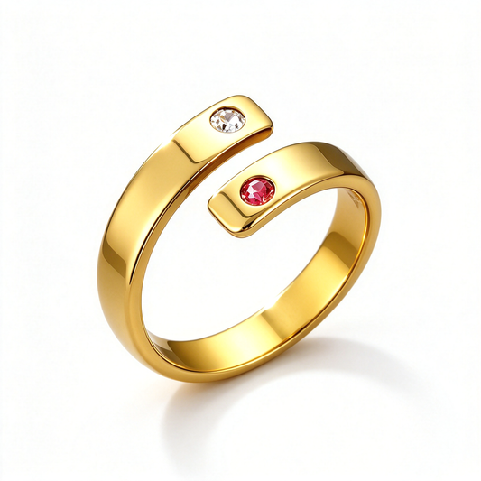 Open wrap ring shown in a gold-tone finish with a clear accent and a red accent.