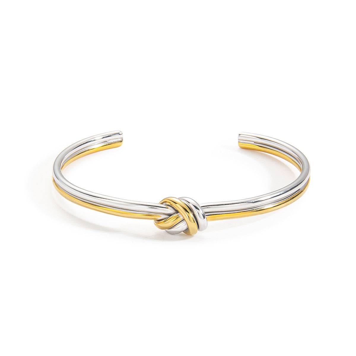 Mixed-metal double-strand knot cuff bracelet shown front-on against white