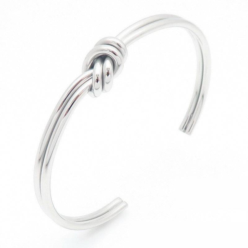 Silver stainless steel double-strand knot cuff bracelet in an angled view