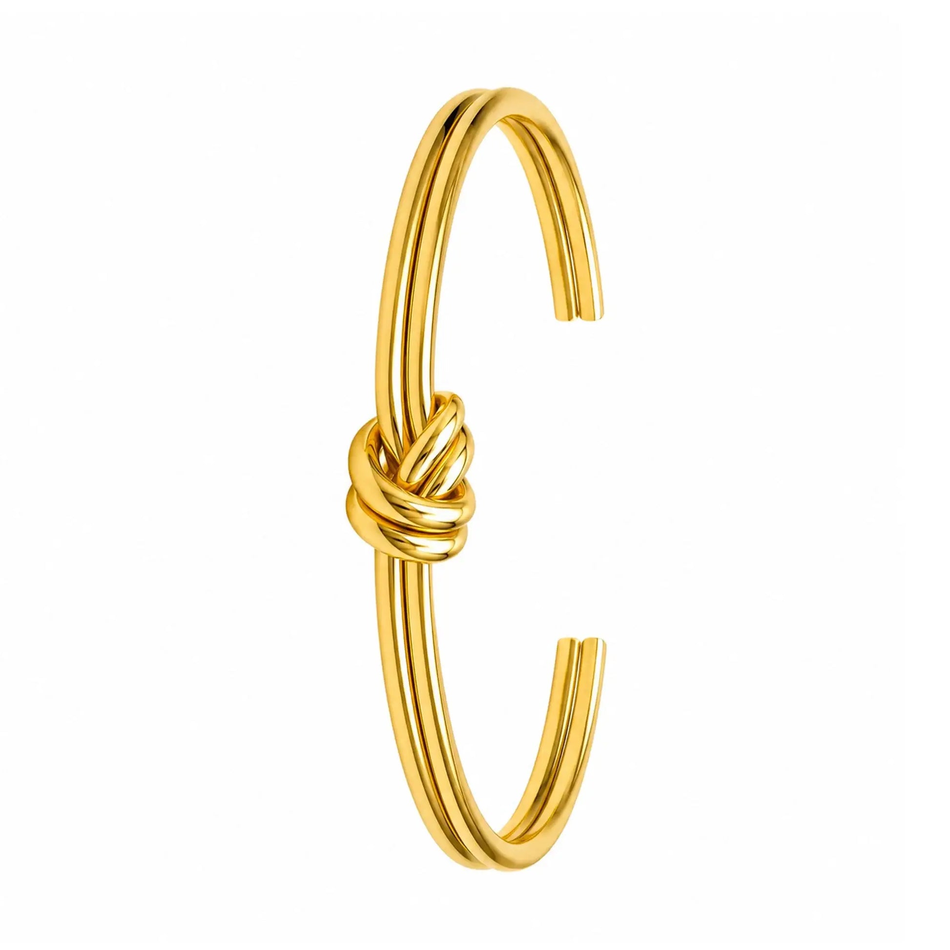 Gold-plated knot cuff bracelet angled to show its open adjustable shape.