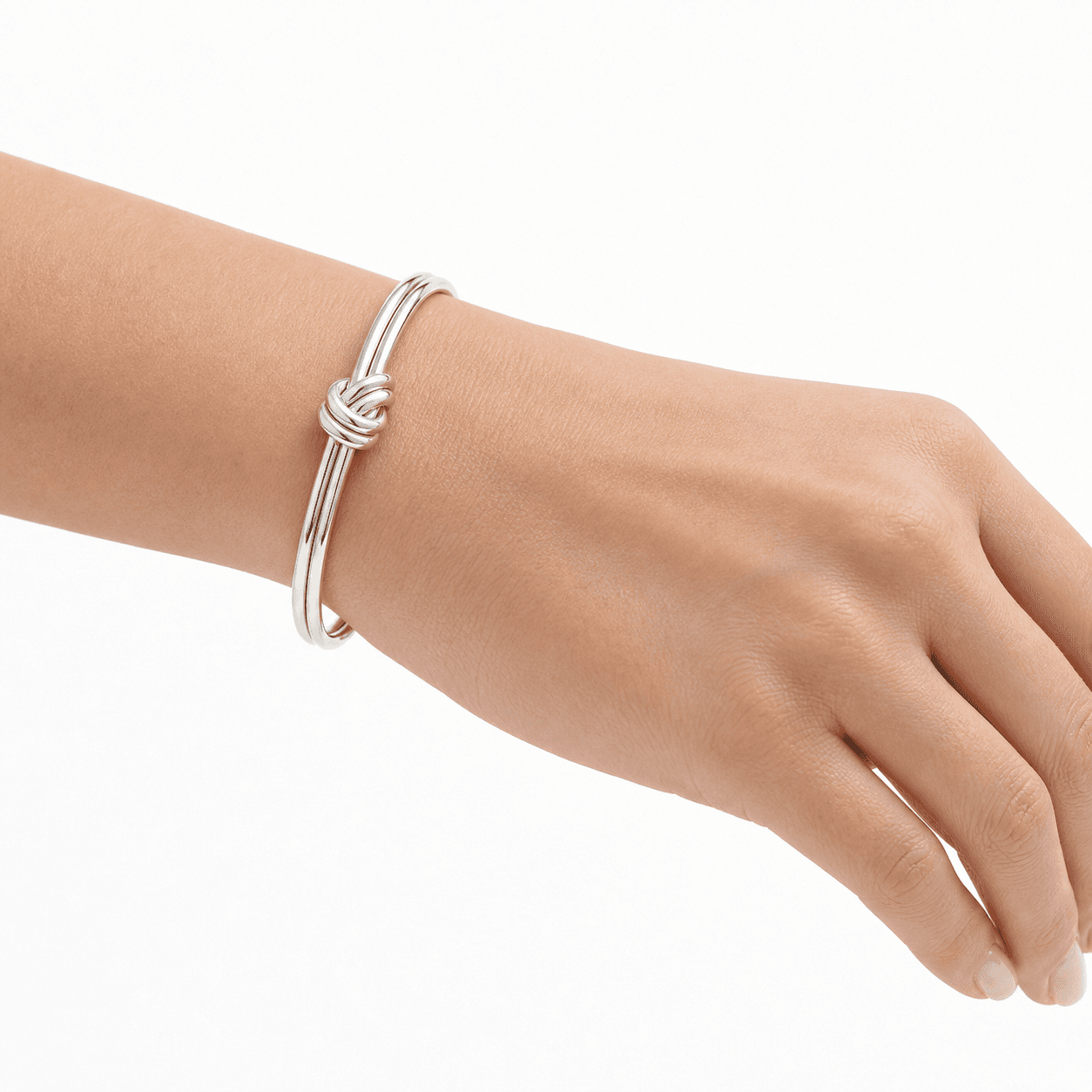 Macro wrist view of a silver stainless steel double-strand knot cuff bracelet