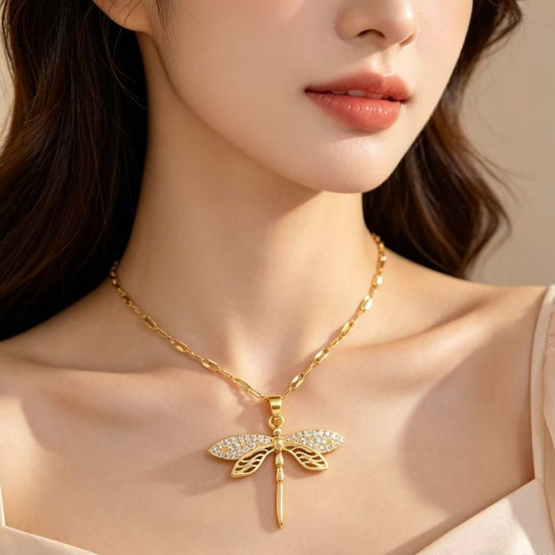 Dragonfly pendant necklace worn with a simple neckline, highlighting the pendant's placement and overall look.