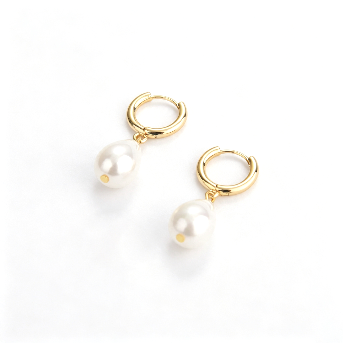 Teardrop drop hoop earrings shown from an angled side view