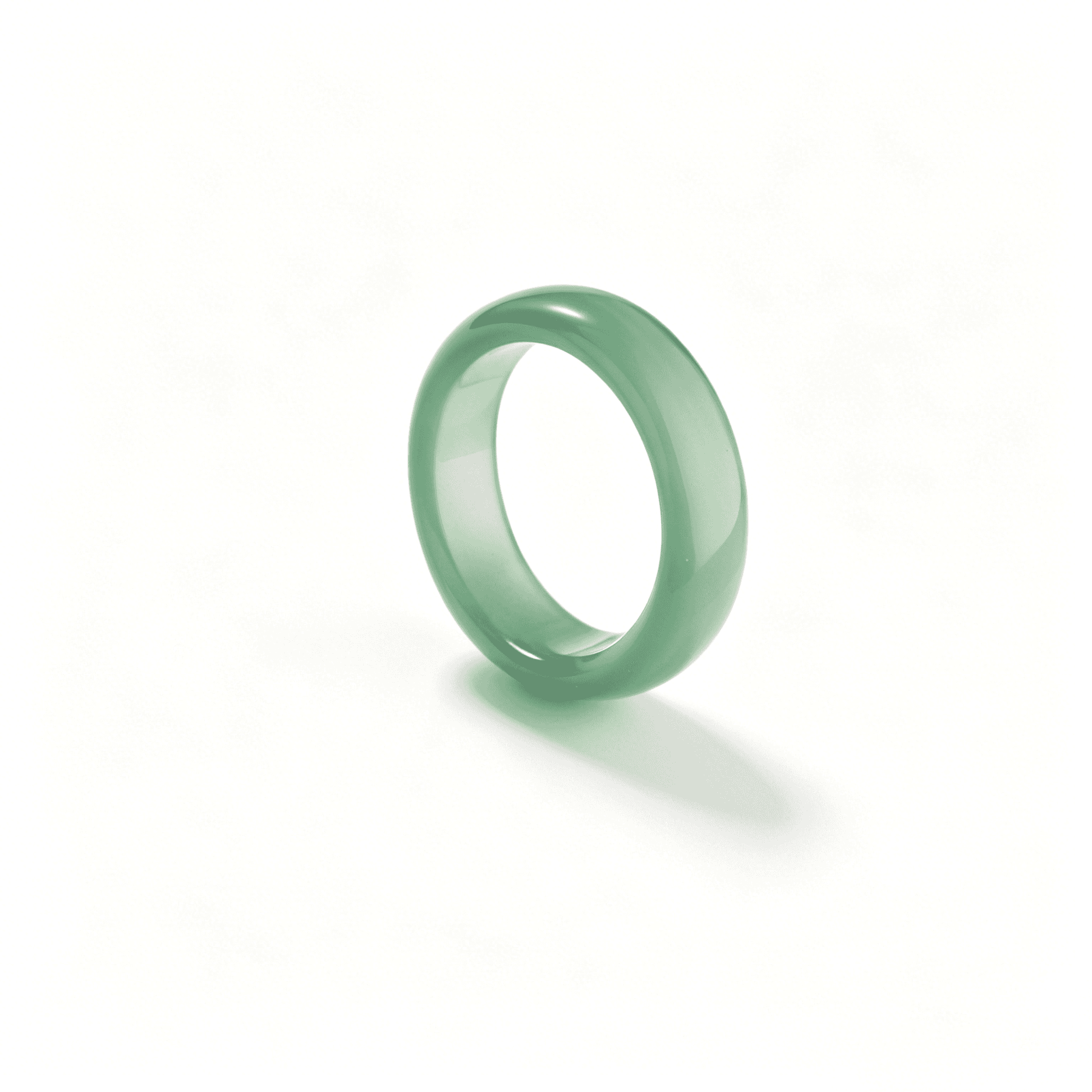 A stack of natural emerald green chalcedony rings by Ever P., showcasing the unique oily luster and varied forest green tones of agate.