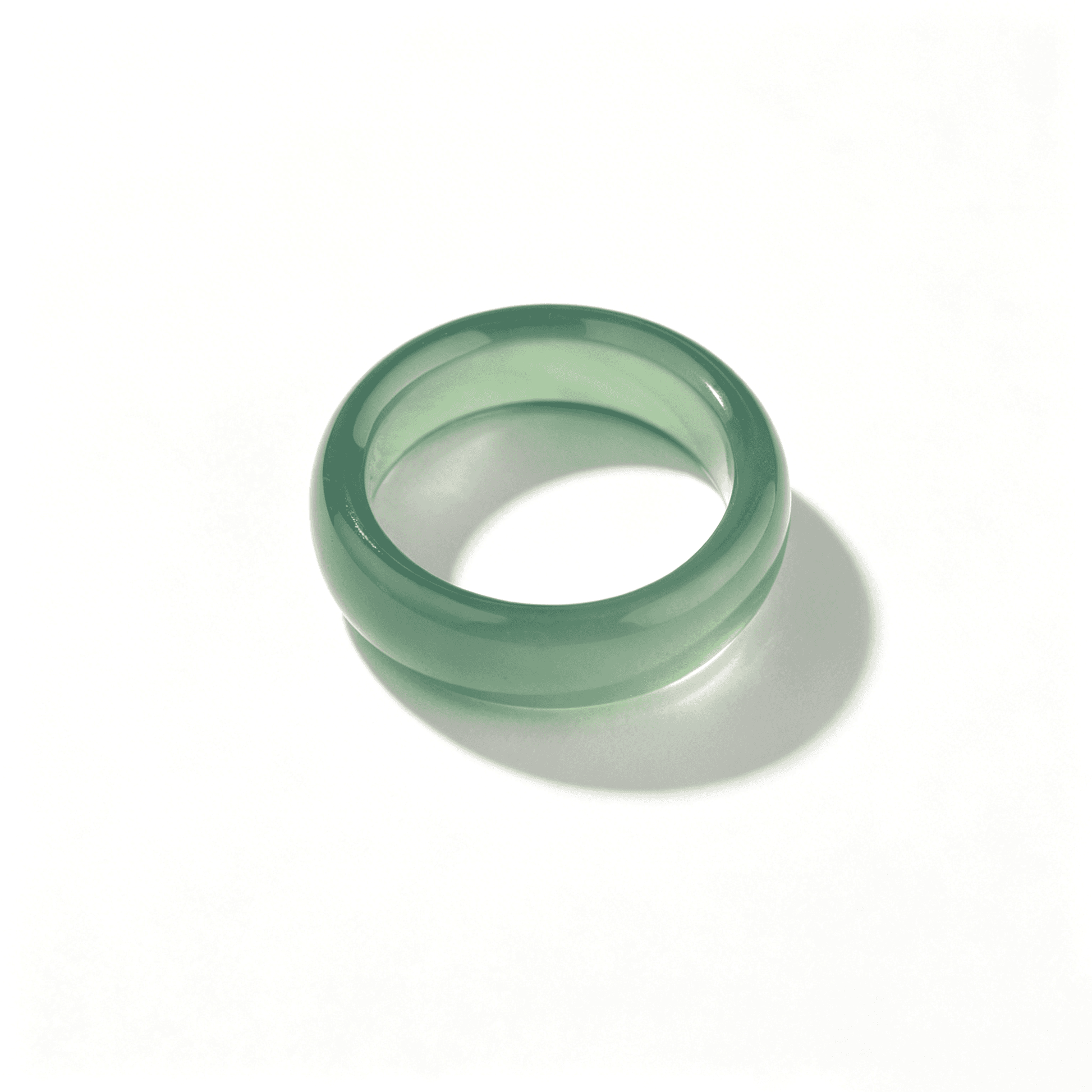 An angled view of a slim emerald green chalcedony ring, designed for a comfortable fit with a minimalist natural stone aesthetic.