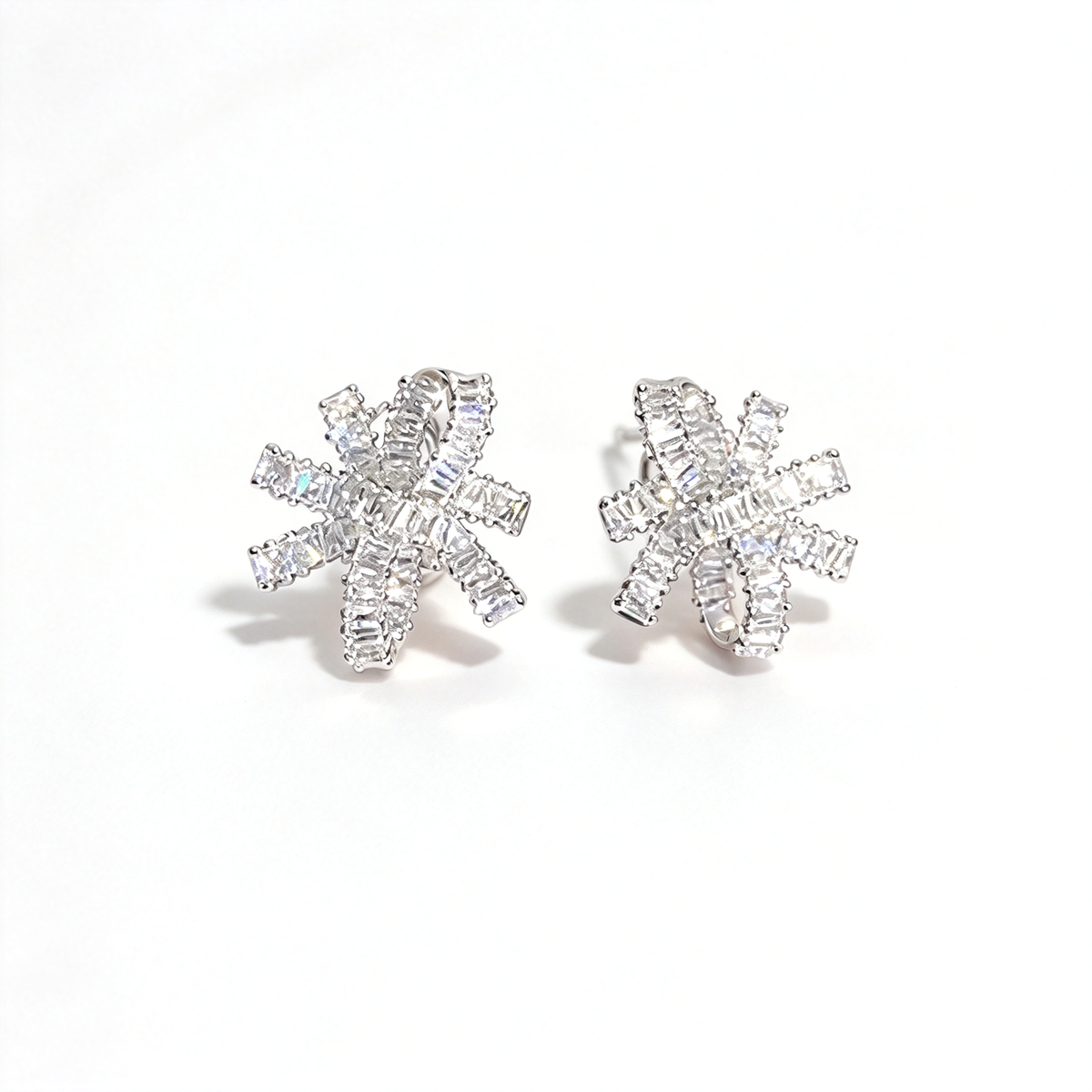 Silver-tone bow knot earrings shown as a matching pair from the front, highlighting their intricate layered design.