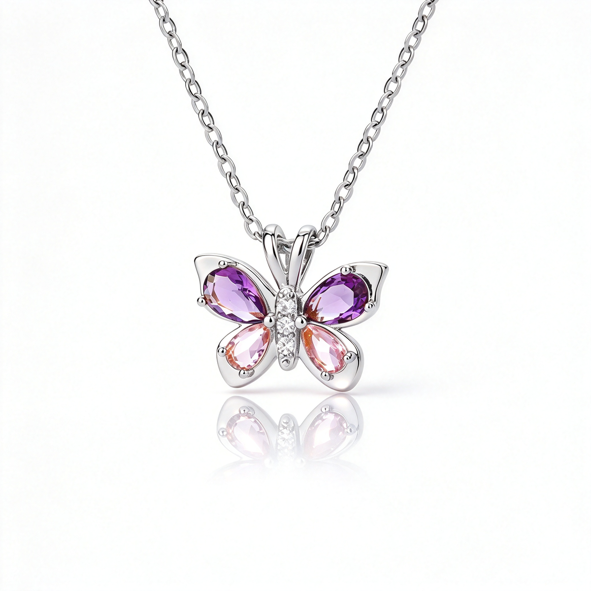 Silver-tone butterfly pendant necklace with purple and pink wings displayed against white