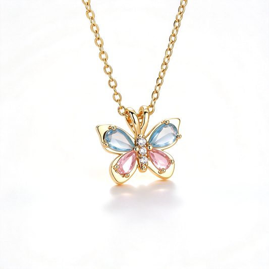 Gold butterfly pendant necklace with blue and pink wings on a white background