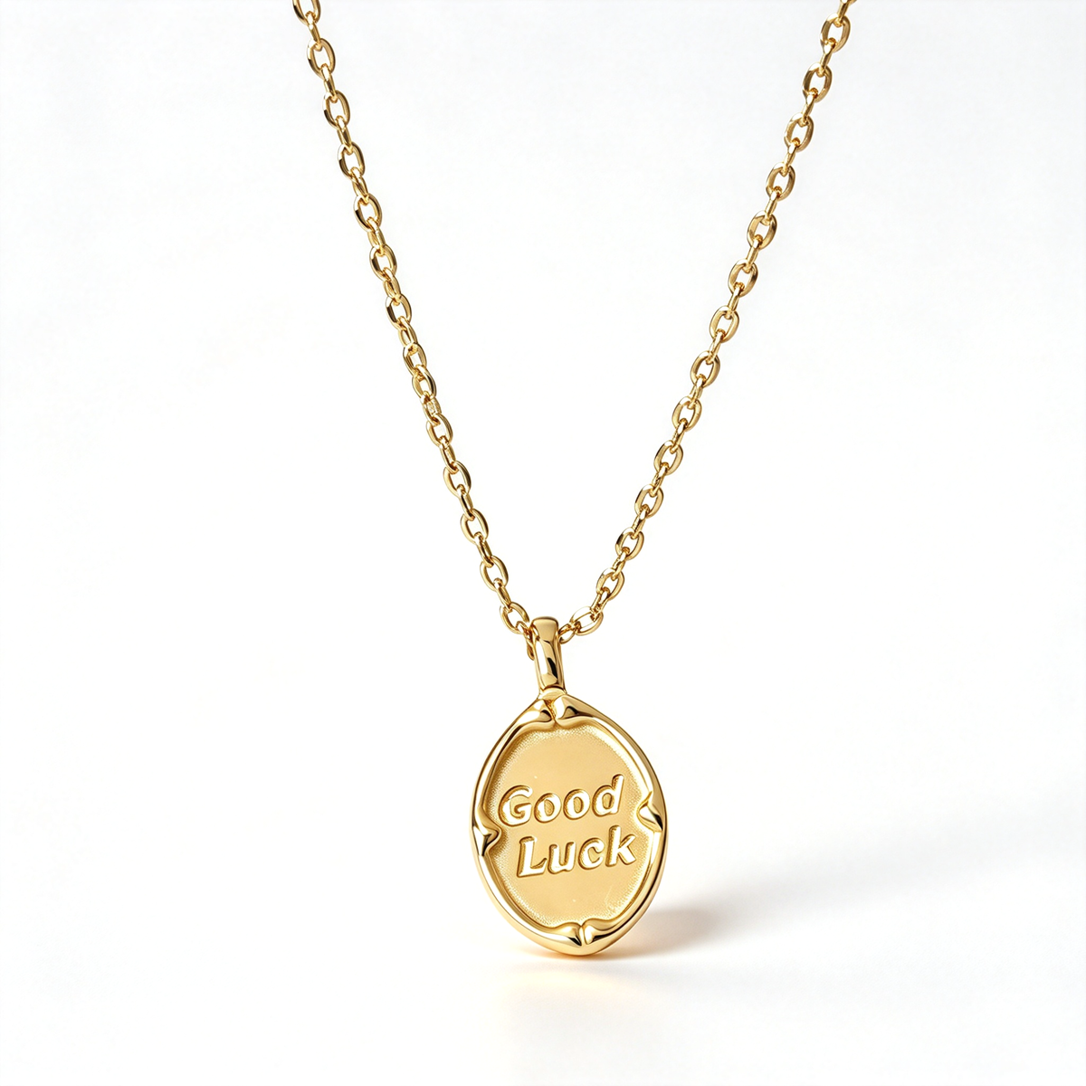 Good Luck pendant necklace with an oval charm displaying engraved lettering, shown against a clean white background.