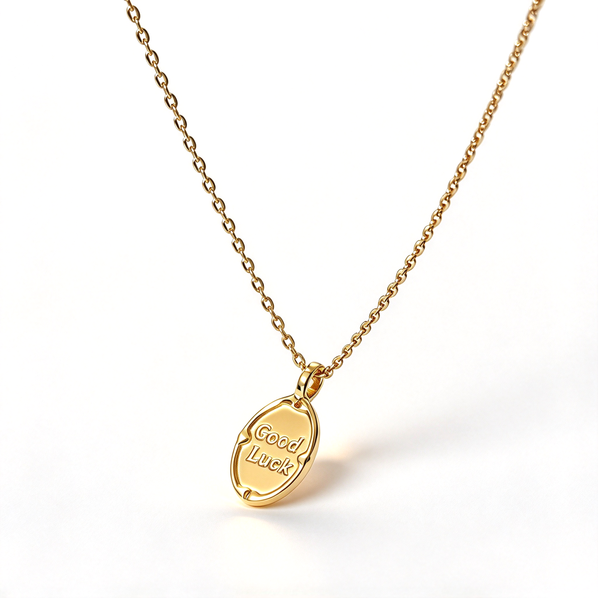 Close-up of the oval pendant showing the Good Luck lettering and decorative border.