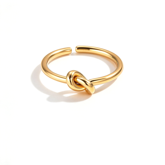 Gold-tone knot open ring with a smooth curved band displayed on a white background.