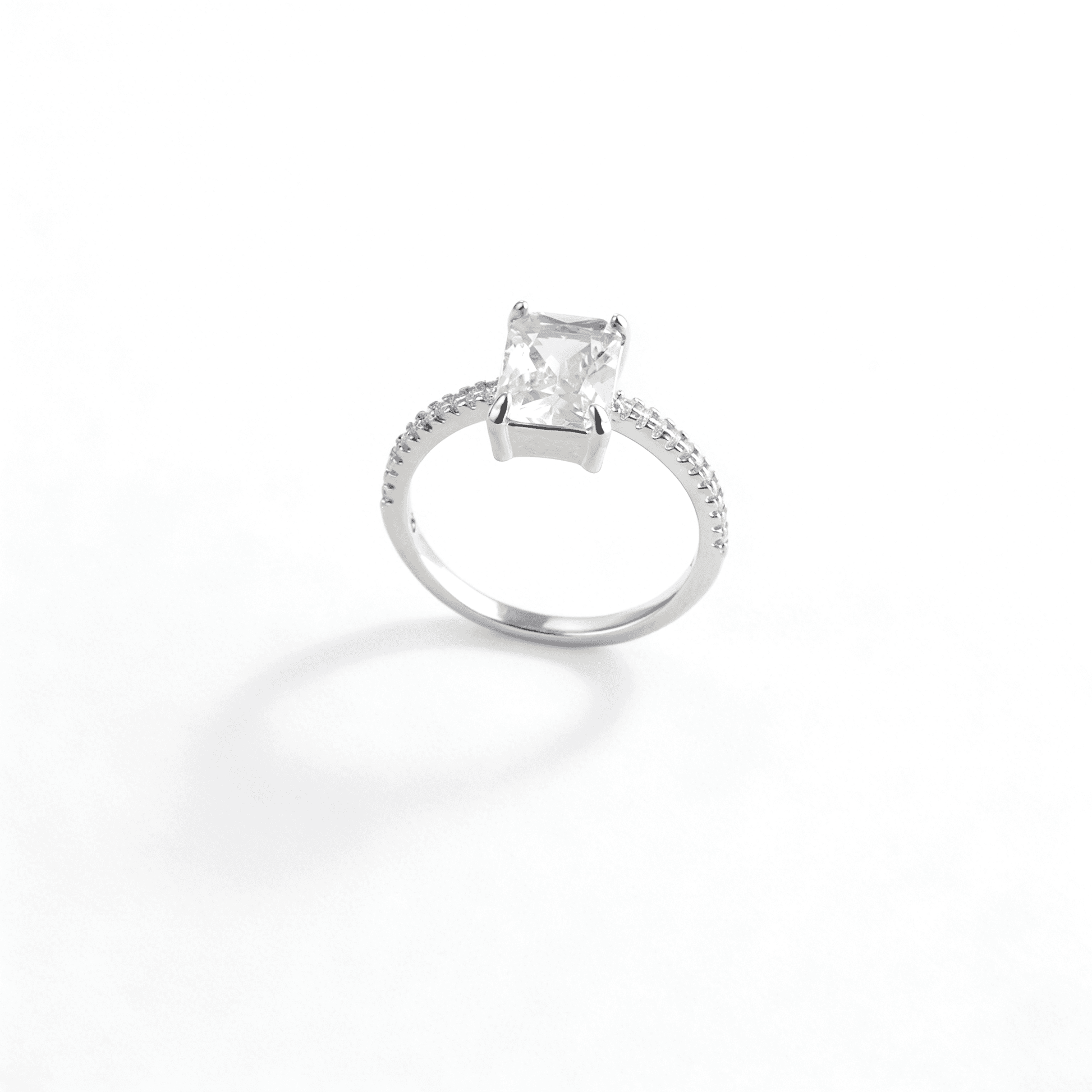 Side profile of Ever P. large carat square cut zirconia ring with a polished gold band.