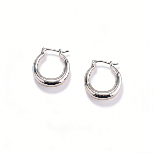 A pair of minimalist silver-plated hoop earrings from Ever P., defining quiet luxury and dainty style.