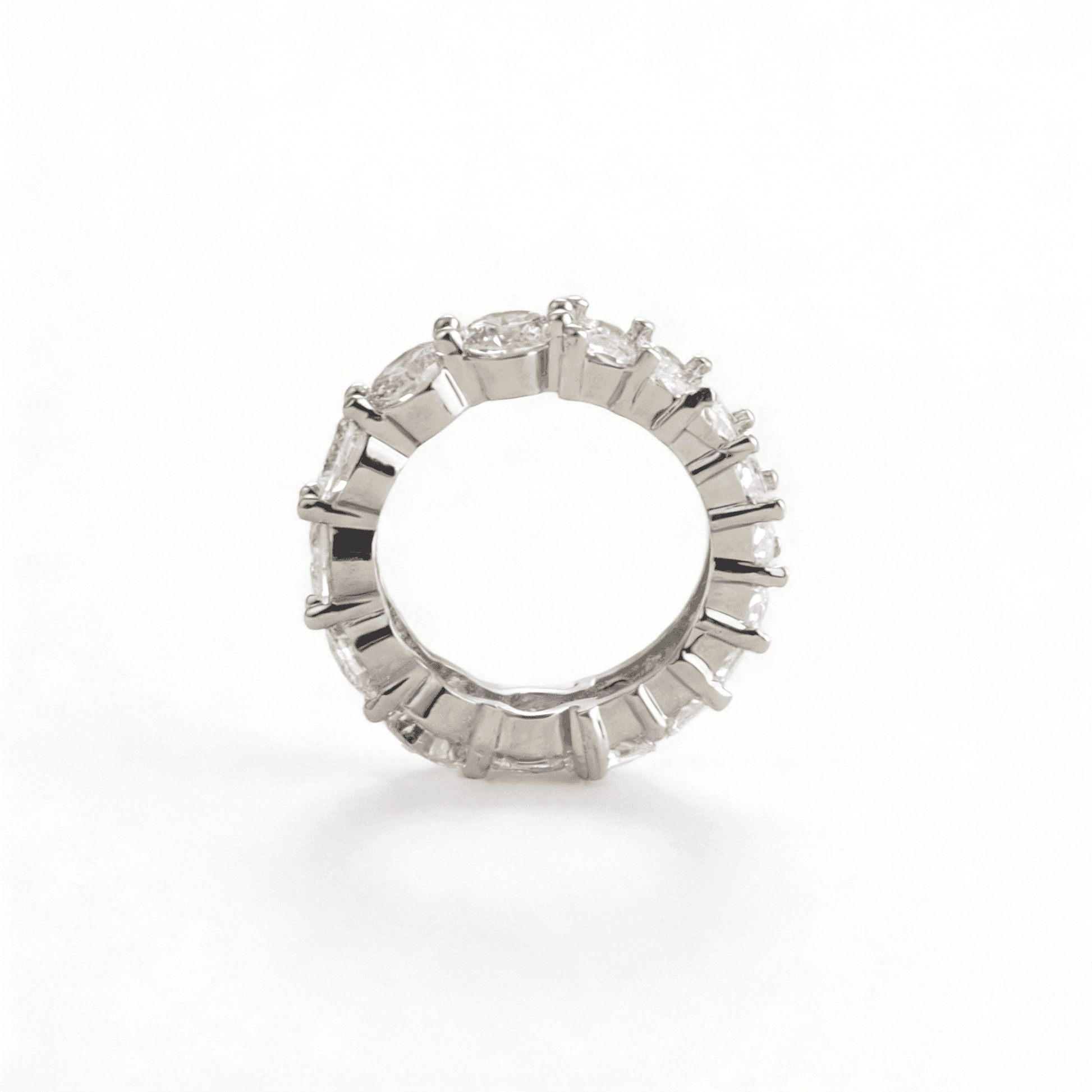 A high-shine profile of the multi-zirconia eternity ring, showcasing the seamless transition between round and baguette-cut stones for bold poise.