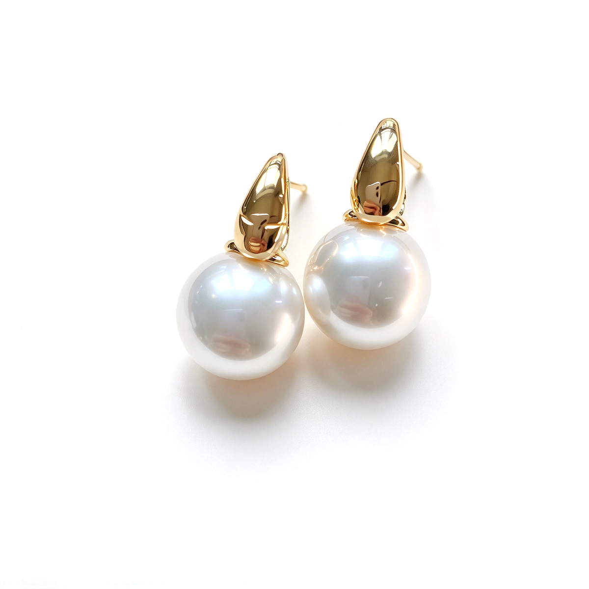 Front view of two drop earrings showing the rounded pearl accents beneath the hoop tops.