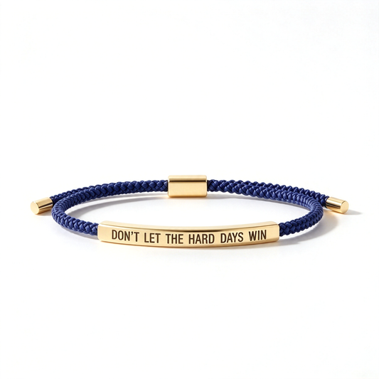 Green braided rope bracelet shown from the front with a silver-tone message bar and matching end caps.