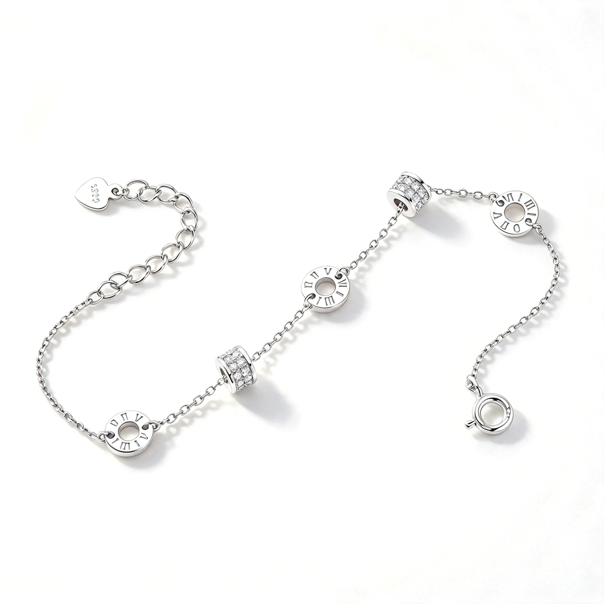 Silver-tone bracelet displayed diagonally with Roman numeral circles and textured barrel accents.