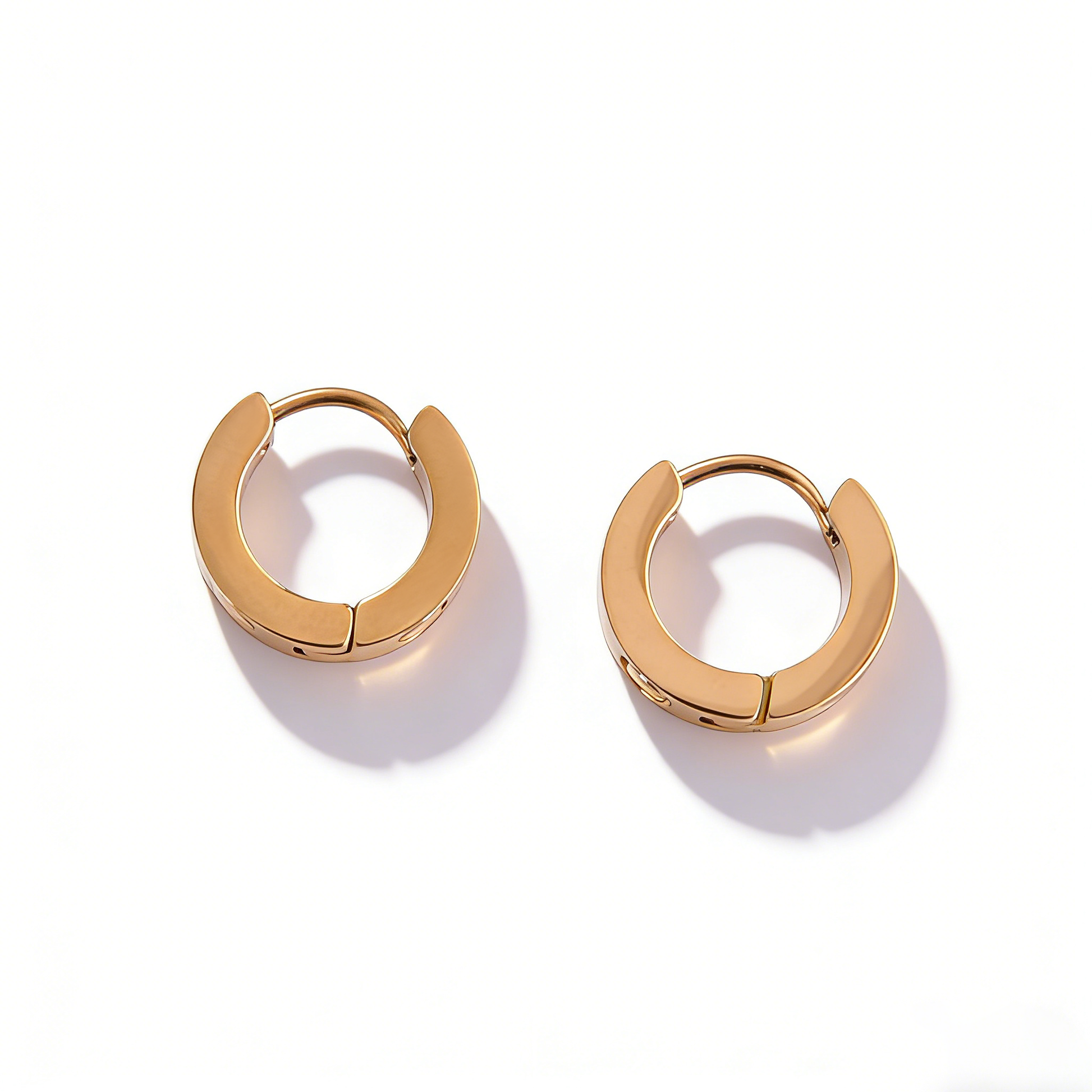 Side profile of dainty rose gold hoops, showcasing a high-polish minimalist style and secure closure.