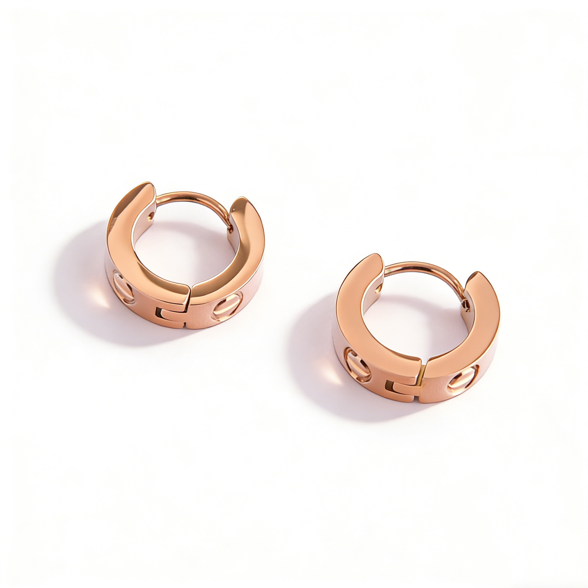 A pair of hypoallergenic rose gold earrings by Ever P., designed as durable and waterproof gold jewelry for her.