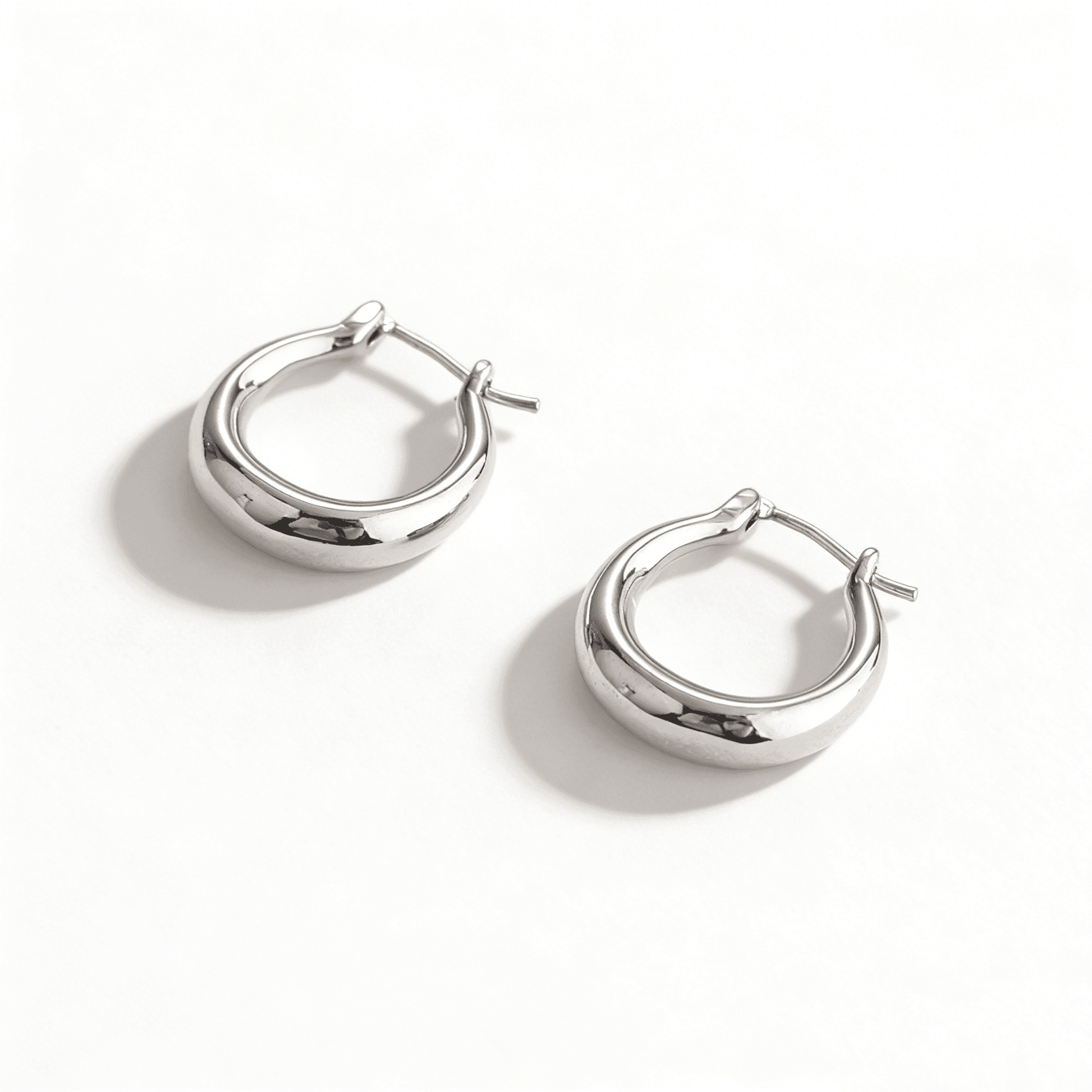 Front-facing view of silver hoop earrings with a modern liquid-metal aesthetic, 1.6cm diameter.