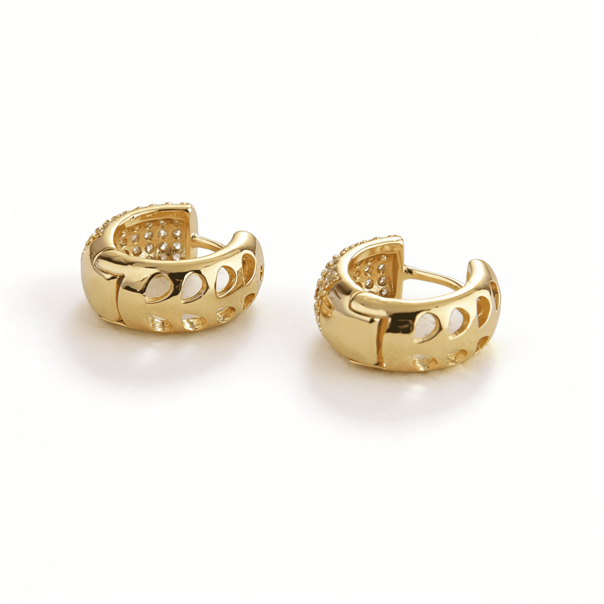Side view of Ever P. small gold hoop earrings featuring unique architectural hollowed-out geometric patterns.