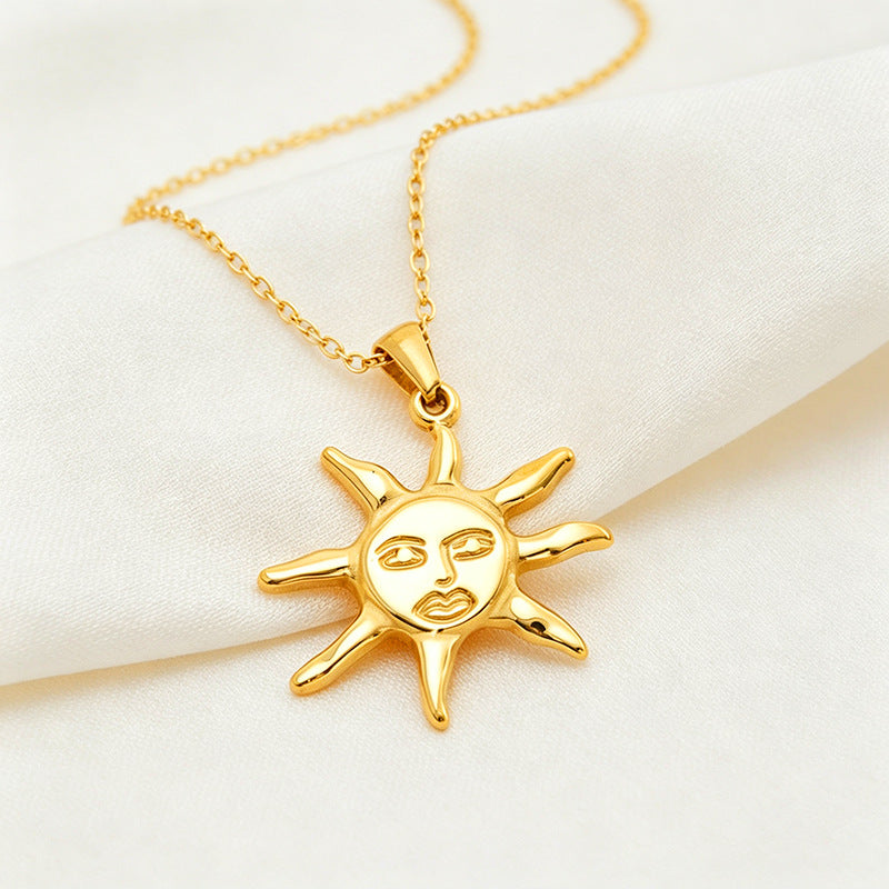 Close-up of the sun pendant showing its raised facial features and curved rays on ivory fabric