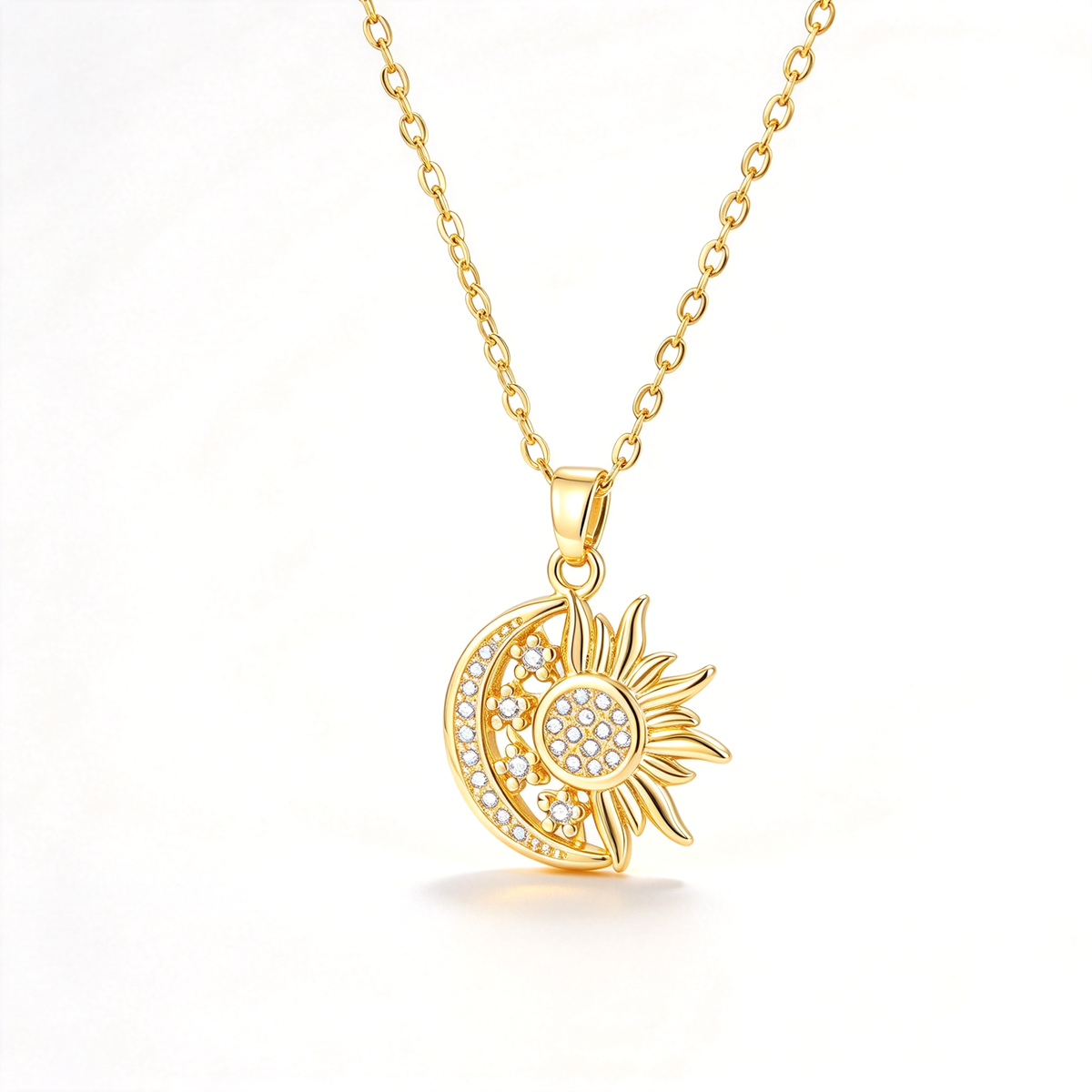 A sun and crescent moon pendant necklace with sparkling decorative details on a clean white background.
