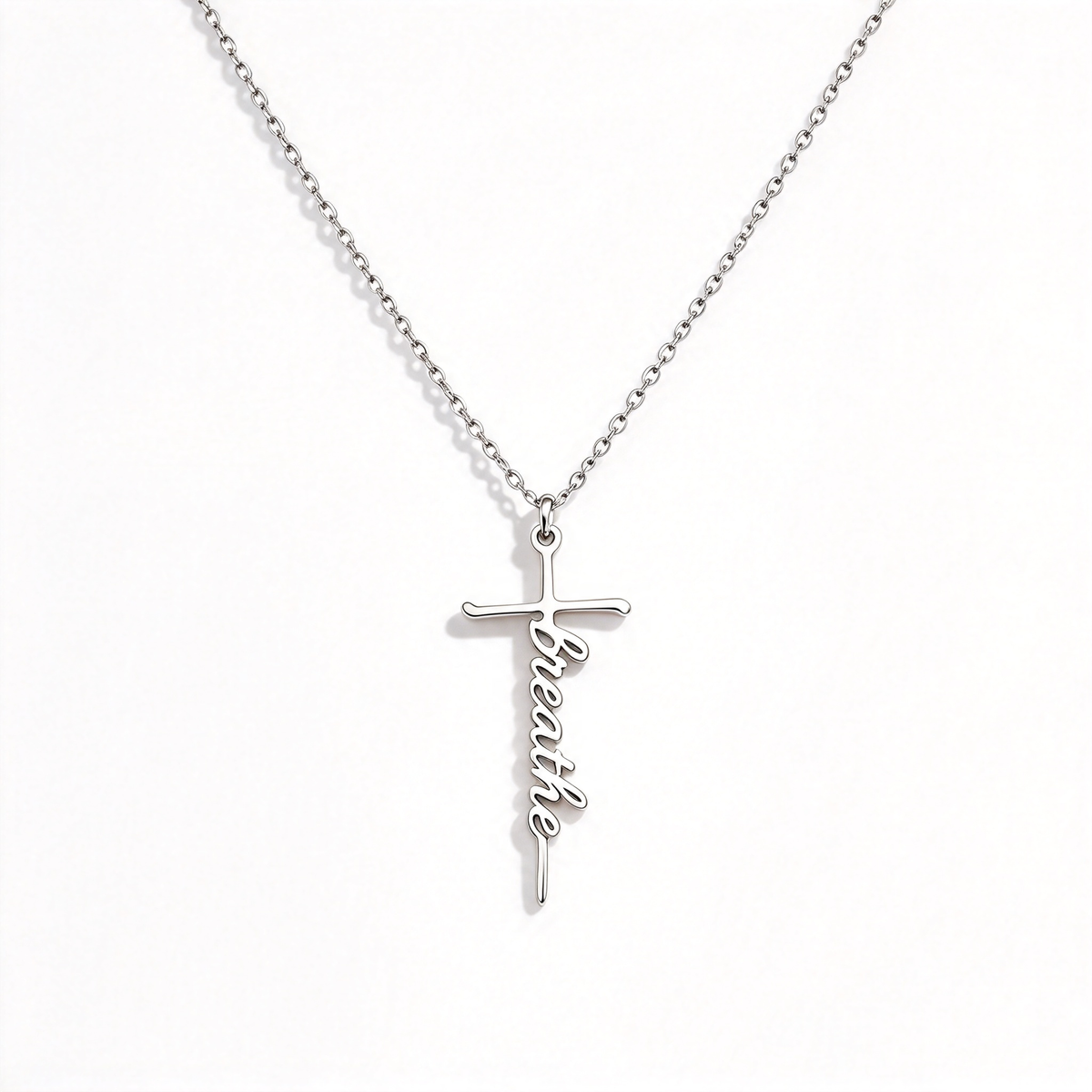 Personalized word cross necklace with script lettering on a fine chain, shown against a white background.
