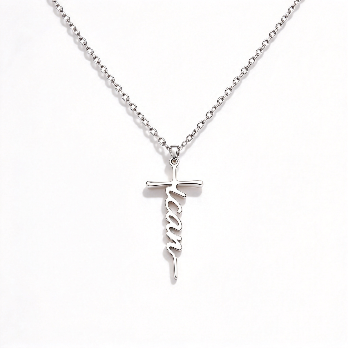 Close view of the vertical script word incorporated into the cross pendant design.