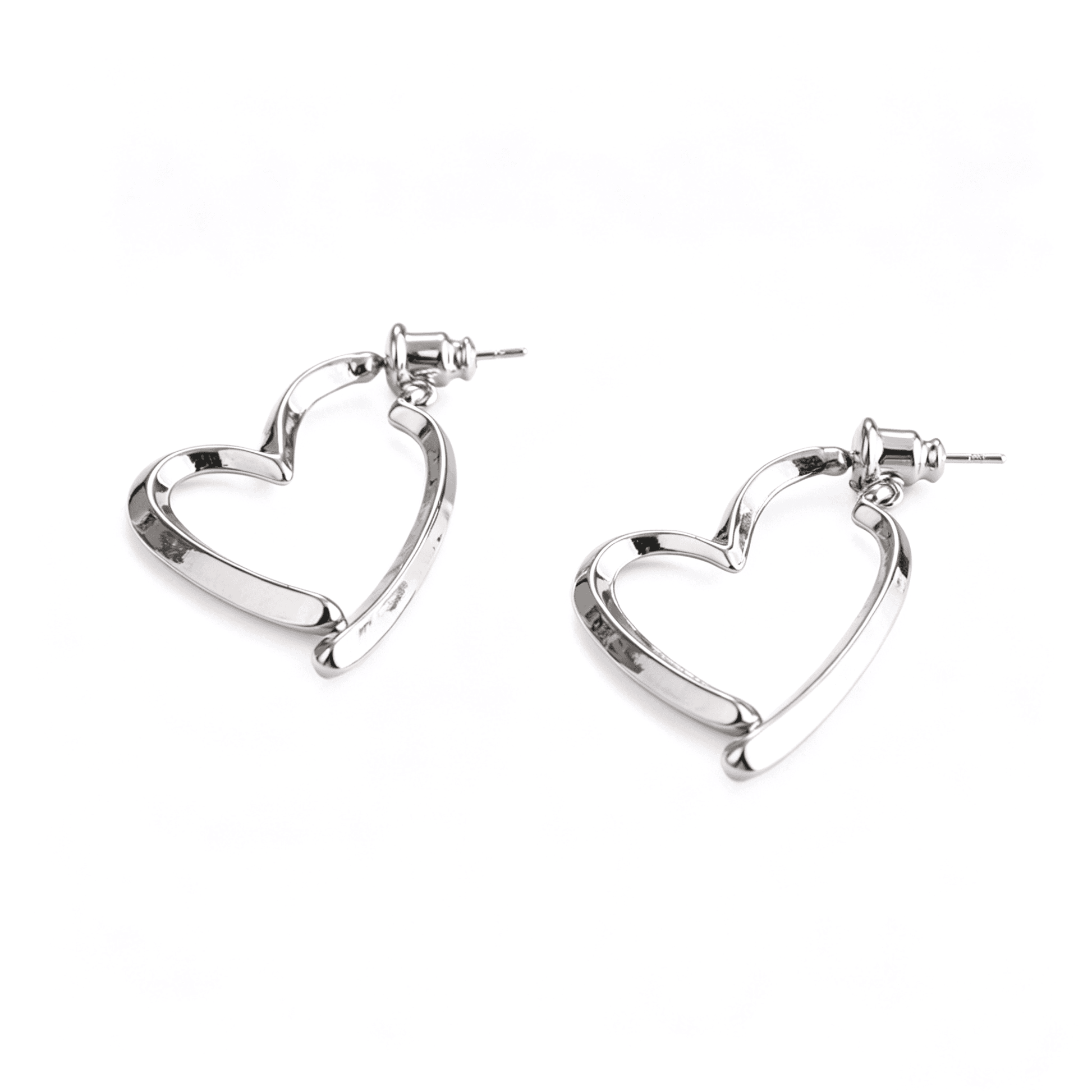 Top angle showing the 2.5*3.5cm statement scale of the individual gold heart earrings.