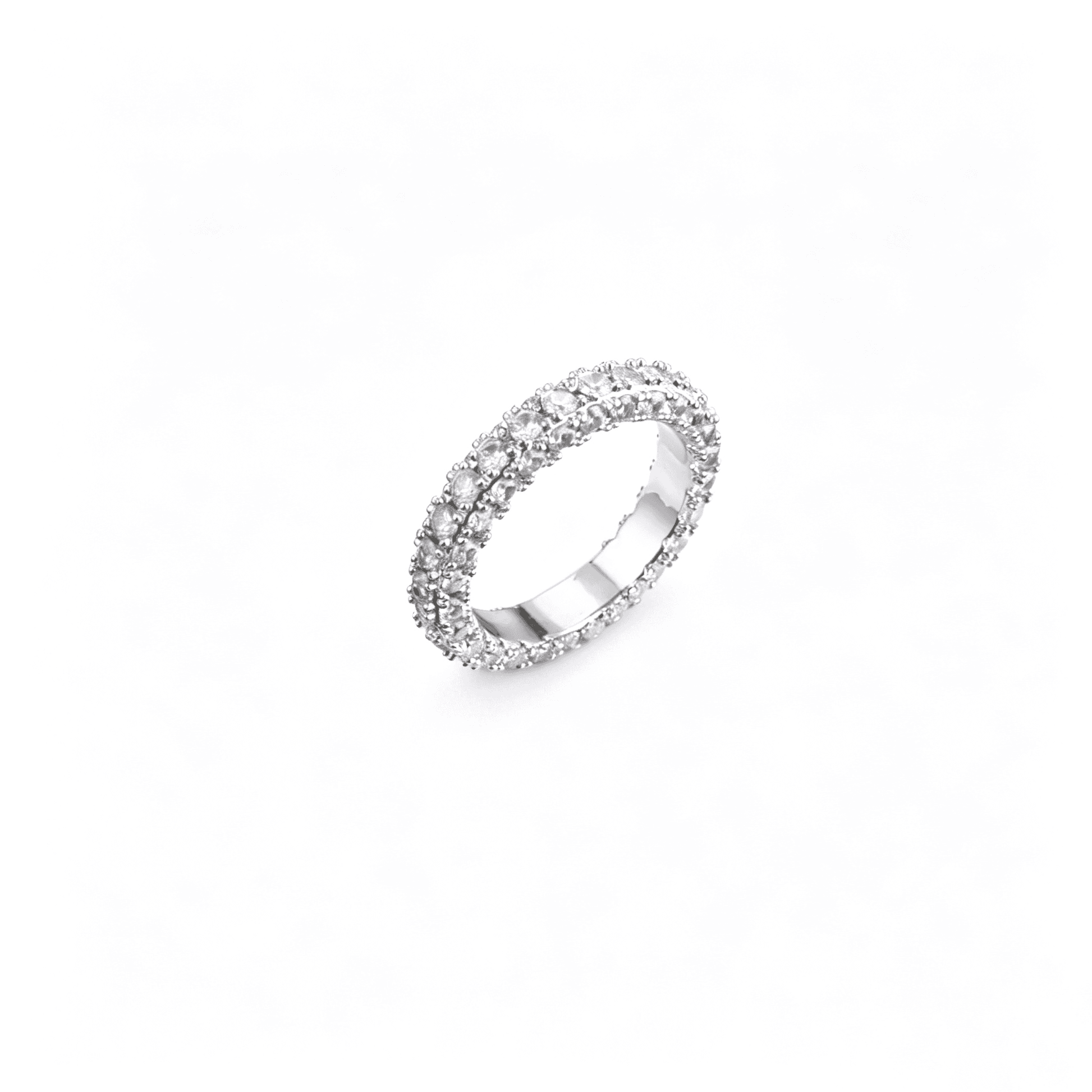 Close-up texture craftsmanship shot displaying the 360-degree light reflection of the cubic zirconia wedding rings.