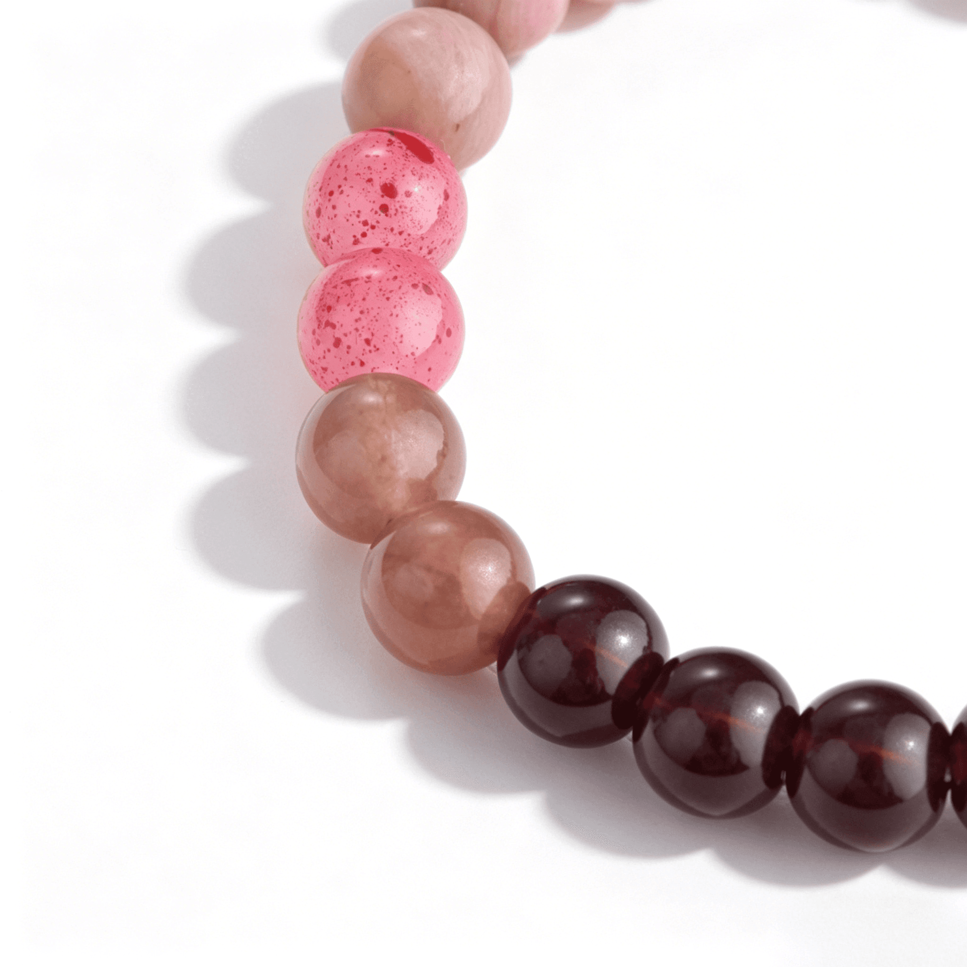 Close-up of Ever P. 6.5mm purple strawberry quartz beads, highlighting the unique starry inclusions in this beaded bracelet.